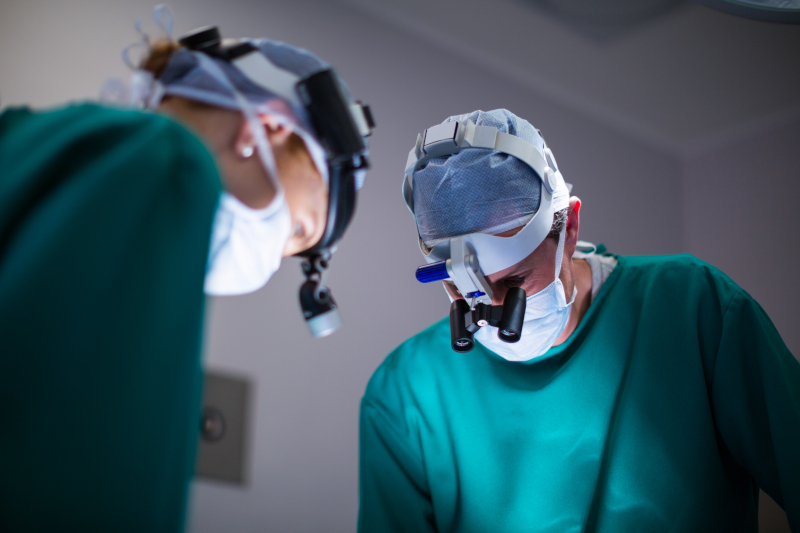 surgeons wearing surgical loupes while performing operation surgeons wearing surgical loupes while performing operation